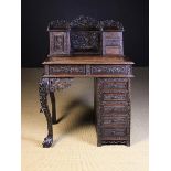 A 19th Century Chinese Export Writing Desk profusely carved with sprays of trailing prunus blossom