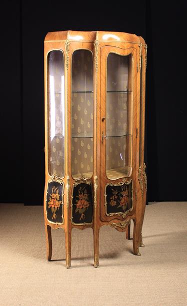 A Louis XV Style Serpentine Vitrine Cabinet clad in diagonally grained veneers with decorative gilt