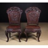 A Pair of Early 20th Japanese Chairs elaborately carved with birds & blossom and standing on