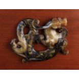 A Fabulous Chinese Two-Colour Brown Jade Carving of a Conjoined Dragon & Phoenix enriched with gold