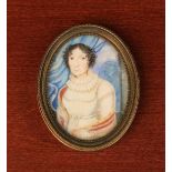 An Early 19th Century Oval Miniature: Half length portrait of a lady, set in a brass frame,