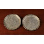 A Pair of Small Persian Silver Dishes with intricate chiselled all-over decoration of scrolling