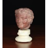 A Carved 'Rosso Antico' Marble Head of a Satyr with Hellenistic influences,