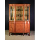 An Edwardian Serpentine Satinwood Display Cabinet with fine ripple grained timbers inlaid with