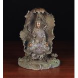 A 19th Century Bronze Guan Yin Buddha seated on a lotus leaf, 11" (28 cm) in height.