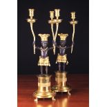 A Pair of Empire Style Bronze & Gilt Bronze Figural Candelabra.