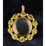 A Pretty Rock Crystal Locket framed in a 15 carat gold surround set with navettes of green enamel