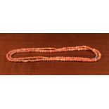 A String of Antique Coral Beads, 31" (79 cm) in length.