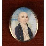 A Georgian Memorial Pendant inset with an oval miniature portrait painted on ivory of a gentleman,