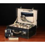 A George V Gentleman's Black Leather Vanity Case fitted with silver mounted implements: Five