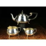 An Art Deco Hammered Silver Three Part Teaset with assay marks for Birmingham 1930.