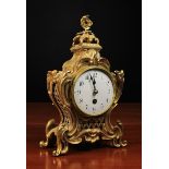 A Small 19th Century Gilt Metal Mantel Clock with a Rococo style scrolling foliate case