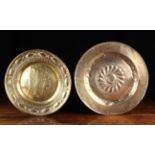 Two 18th Century Brass Repoussé Alms Dishes embellished with punchwork: The largest centred by a