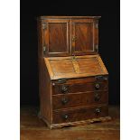 An Early 19th Century Miniature Elm Bureau Cabinet.