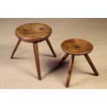 Two 19th Century Milking Stools: One with a thick bowl shaped top morticed through with three