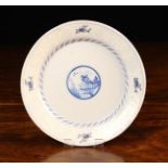 An 18th Century Bristol Bianco-Sopra-Bianco Delft Plate painted in blue with a scenic roundel to