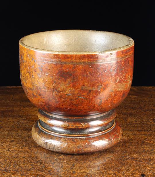 A Large Antique Turned Treen Mortar/Bowl raised on a moulded foot with turned hollow to the