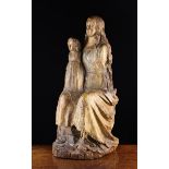 A 17th Century Polychromed Wood Sculpture carved with seated Madonna & Child with residual gilding