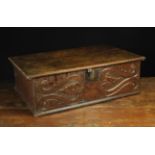 An Early 18th Century Boarded Oak Desk Box. The hinged lid with chip carved ends.