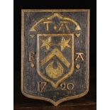 An 18th Century Oak Shield Shaped Armorial Panel carved with a cut-away ground displaying an inner