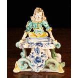 An Antique Maiolica Figural Salt (A/F) modelled as a girl sat behind a rectangular basin raised on