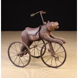 A Late 19th/Early 20th Century Black Forrest Bear Tricycle carved in the form of a saddled bear