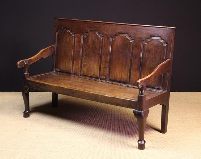 A 19th Century Joined Oak Settle. The back composed of four ogee topped fielded panels.