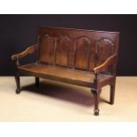 A 19th Century Joined Oak Settle. The back composed of four ogee topped fielded panels.