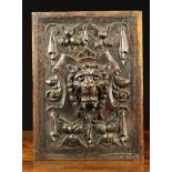 A 19th Century Renaissance Revival Oak Panel carved in relief with a lion mask on scrolled