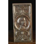 A Rare 16th Century Carved Oak Romayne Panel with a portrait of a bald headed man shouting in a