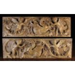 A Fine Pair of Relief Carved Oak Panels depicting winged cherubs and chimeras amidst undulating