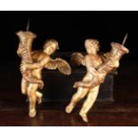 A Pair of Italian Giltwood Figural Candle Sconces carved in the form of airborne cherubs with wind