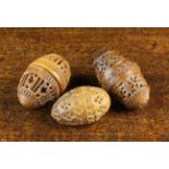 Three 19th Century Coquilla Nut Egg-shaped Pomanders pierced and carved in intricate detail.