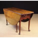 A Georgian Walnut Drop Leaf Dining Table of good colour and patination.