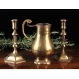 An 18th Century French Brass Jug of oval baluster form with a reeded rim,