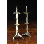 A Pair of Gothic Revival Brass Pricket Candlesticks with fillet knopped hexagonal stems leading