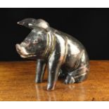 A Carved & Painted Butcher's Sign in the form of a seated pig, 10" (26 cm) high,