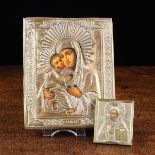 Two Small Icons each with an embossed brass riza covering printed depictions of Christ Pantocrator