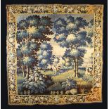 A 17th Century Flemish Verdure Tapestry depicting a landscape of leafy trees and flowering shrubs;