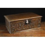 A 17th Century Oak Desk Box carved with arabesque strap-work to the front and having a moulded lid,