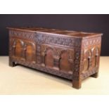 A Large 17th Century Joined Oak Coffer. The lid composed of five panels in a moulded frame.