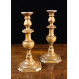 A Pair of George III Turned Fruitwood Candlesticks with decorative knopped stems on canted square