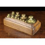 A Set of Eleven Antique Continental Weights ranging from 2 Kilos to 5 grams of cylindrical form