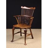 A Small Comb Backed Windsor Armchair on Cabriole legs.