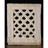 An 18th Century Stone Grille pierced and carved with a repeated symmetrical design and measuring