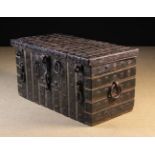A 16th/17th Century Wrought Iron Strong Box of rectangular form bound all over in studded straps