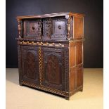 A 19th Century Jacobean Style Inlaid Oak Court Cupboard enriched with carving and inalid with