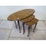 A nest of three walnut tables