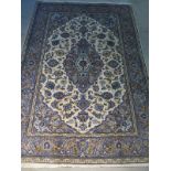 A hand knotted woollen Kashan rug with caucasian ground, approx. 204cm x 140cm, some light signs