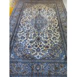 A hand knotted woollen kashan rug, with caucasian ground, approx. 293cm x 194cm, in good condition